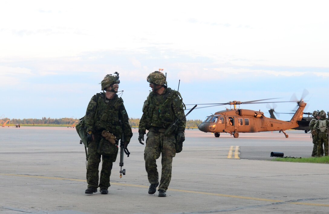 The morning sun begins to shine on Canadian Soldiers with 3rd Battalion Princess Patricia's Canadian Light Infantry after an intense night of simulated combat near Canadian Forces Base Cold Lake, May 27, 2016.  The night operation was part of Exercise Maple Resolve, a joint multinational military exercise that included U.S. Army aviation assets, as evidenced by the U.S. UH-60 helicopter sitting in the background. (U.S. Army Sgt. William A. Parsons, 214th Mobile Public Affairs detachment)(Released)