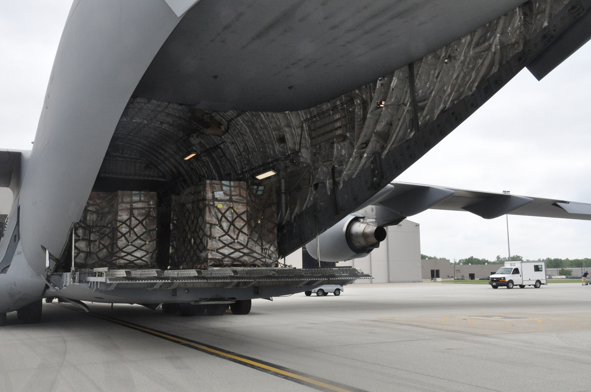 More than 102,000 pounds worth of rice and beans are loaded into the cargo area of a 445th Airlift Wing C-17 Globemaster III bound for Haiti May 26, 2016. The food, provided by Kids Against Hunger, a ministry of A Child's Hope International from Cincinnati, Ohio, was shipped to Haiti as part of the Denton Program. (U.S. Air Force photo/Stacy Vaughn)