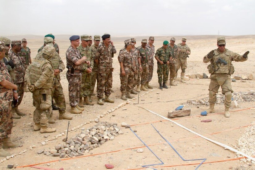 U.S. Army Maj. Steven Veves, the operations officer for 2nd Armored Brigade Combat Team, 1st Infantry Division, briefs the concept of the operation to Lt. Gen. Michael X. Garrett, U.S. Army Central commanding general, and Prince Faisel Bin Hussein, the deputy supreme commander of the Jordan Armed Forces, and others prior to the combined arms live fire exercise for Eager Lion 16 at the Joint Training Center, Jordan, May 24, 2016.