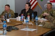 The Honorable Katherine Hammack, the assistant secretary of the Army for installations, energy and environment, Brig. General John S. Laskodi, with the Department of the Army Headquarters logistics office and Col. Jeff Stewart, commander of Area Support Group-Kuwait, prepare for a briefing in a conference room at the Kuwait Naval Base, Kuwait, May, 24, 2016. The delegation received a brief on partnership opportunities with Kuwaiti military and installation operations before visiting sites on the base.