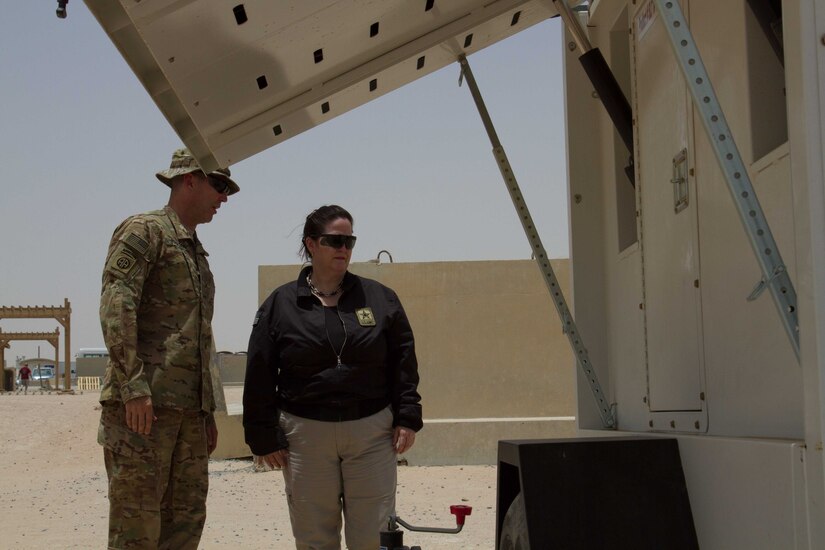 Lt. Col. Lee Johnson, the Camp Buehring base commander, briefs the Honorable Katherine Hammack, the assistant secretary of the Army for installations, energy and environment, on the solar powered light system project at bases throughout the U.S. Army Central area of responsibility May, 24, 2016. USARCENT plans to replace diesel powered light systems with the more energy efficient solar-powered systems.