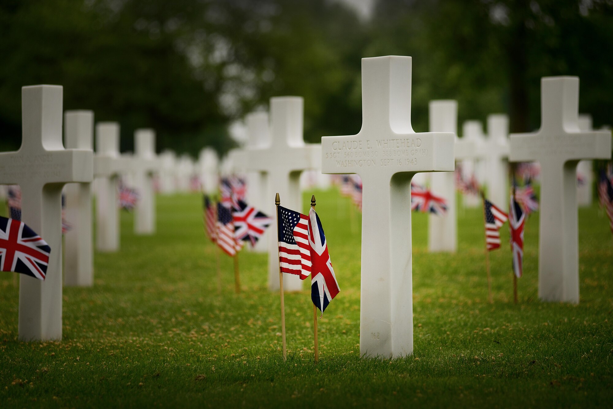 Hundreds gathered to honor the memory of the thousands of U.S. Soldiers, Sailors, Marines and Airmen who made the ultimate sacrifice in the service of their nation on Memorial Day, May 30, at Madingley American Cemetery in Cambridge, England. The cemetery contains 3,812 headstones and a Wall of the Missing, which stands nearly 500 feet in length and contains the names of more than 5,000 men from the U.S. Army, Army Air Corps, Navy, Marine Corps and Coast Guard who are still listed as missing-in-action, buried at sea or unaccounted-for. (U.S. Air Force photo/ Tech Sgt. Matthew Plew)