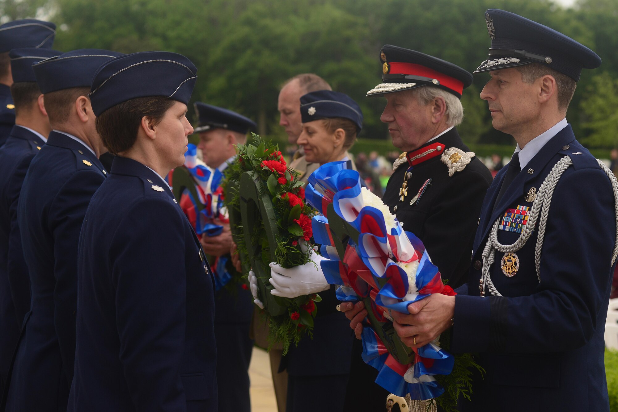 Sir Hugh Duberly, Her Majesty’s Lord-Lieutenant of Cambridgeshire and U.S. Air Force Brig. Gen. Dieter Bareihs, U.S. Senior Defense Attaché in London, accept their respective wreaths prior to placing them at the base of the Wall of the Missing on Memorial Day, May 30, at Madingley American Cemetery in Cambridge, England. Hundreds gathered to honor the memory of the thousands of U.S. Soldiers, Sailors, Marines and Airmen who made the ultimate sacrifice in the service of their nation. (U.S. Air Force photo/ Tech Sgt. Matthew Plew)