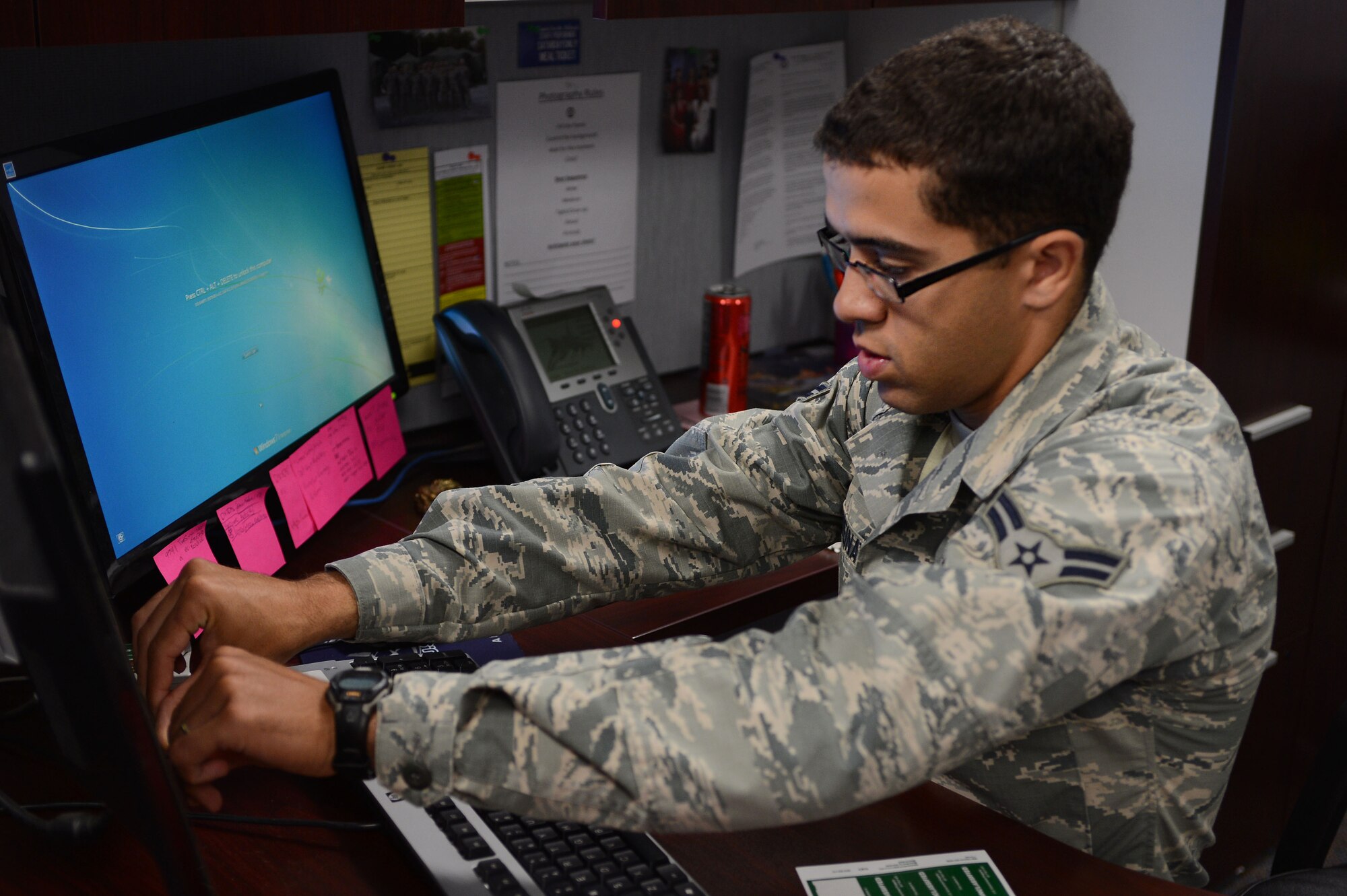 U.S. Air Force Airman 1st Class Raji Jweinat, 20th Communications Squadron cyber security technician, places a sticker on a computer monitor to identify it as appropriate for viewing only unclassified material on Shaw Air Force Base, S.C., May 31, 2016. Several 20th CS Airmen visited various agencies on base in order to resolve outstanding problems in preparation for the upcoming Command Cyber Readiness Inspection. (U.S. Air Force photo by Senior Airman Zade Vadnais)