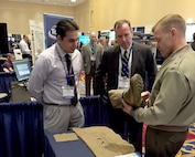 Brig. Gen Joseph Shrader, commander of Marine Corps Systems Command, looks over the Dry Super Absorbing Fabric, or DrySAF, during the Navy’s Forum for Small Business Innovation Research/Small Business Technology Transfer Transition May 16. MCSC’s SBIR/STTR program gives small businesses the opportunity to develop innovative advances in technologies to address Marine Corps needs. (U.S. Marine Corps photo by Barb Hamby)