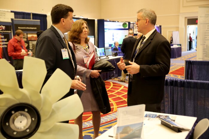 Jim Smerchansky, executive director of Marine Corps Systems Command, and Jeannette Evans-Morgis, deputy commander for Systems Engineering, Interoperability, Architectures and Technology at MCSC, listen to a presentation for a fan drive that improves fuel efficiency during the Navy’s Forum for Small Business Innovation Research/Small Business Technology Transfer Transition May 18. MCSC’s SBIR/STTR program gives small businesses the opportunity to develop innovative advances in technologies to address Marine Corps needs. (U.S. Marine Corps photo by Mathuel Browne)