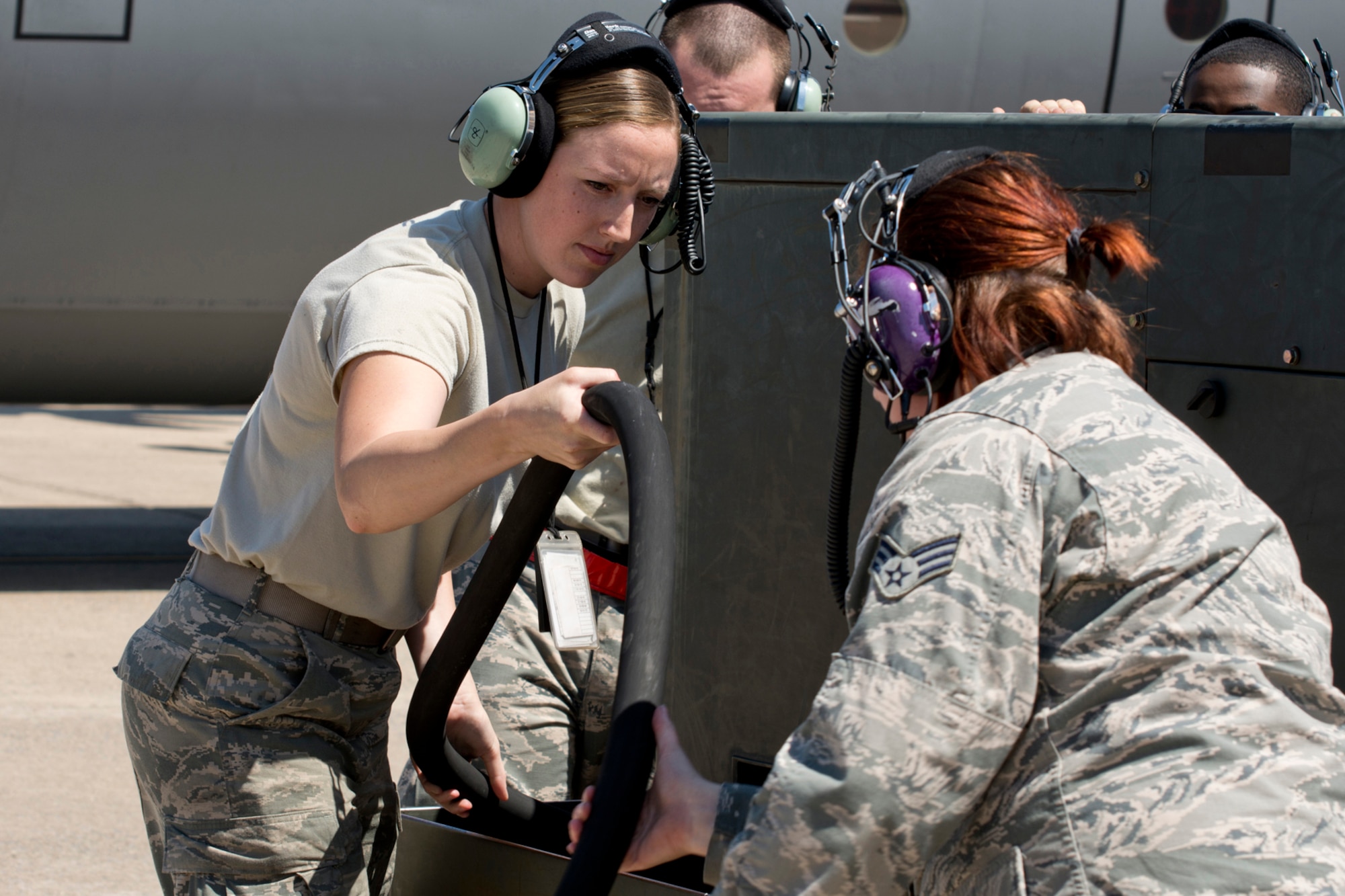 (Left) U.S. Air Force Reserve Senior Airmen Jennifer Franke helps stow a power cart cable at Little Rock Air Force Base, Ark, May 13, 2016. Franke is a crew chief assigned to the 913th Maintenance Squadron, and was part of the Reserve maintenance crew that helped launch the first all Reserve aircrew mission in a C-130J aircraft for the 913th Airlift Group since its transition from the “H” model. (U.S. Air Force photo by Master Sgt. Jeff Walston/Released)   