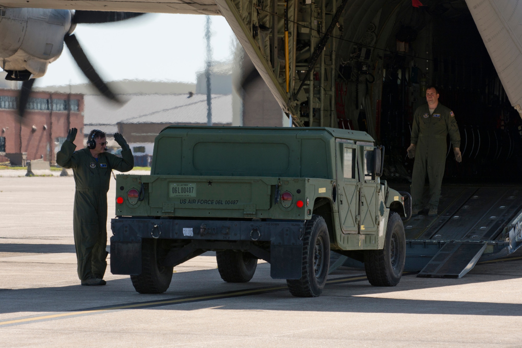 U.S. Air Force Reserve Chief Master Sgt. Steve Tarrance, (Right) and Tech. Sgt. Nick Crawford, direct the off load of a Humvee from a C-130J at Little Rock Air Force Base, Ark., May 13, 2016. Both Airmen are loadmasters assigned to the 327th Airlift Squadron, and were participating in a “Turkey Shoot,” a tactical airlift competition against five other aircraft and aircrews from Little Rock AFB. (U.S. Air Force photo by Master Sgt. Jeff Walston/Released) 