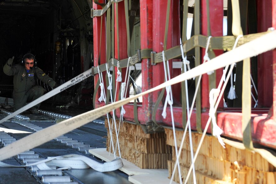 U.S. Air Force Reserve Chief Master Sgt. Steve Tarrance, a 327th Airlift Squadron loadmaster, directs a container-delivery system into a C130J at Little Rock Air Force Base, Ark., May 13, 2016. The aircraft and crew competed in a “Turkey Shoot,” a tactical airlift competition against other aircrews from Little Roack AFB. (U.S. Air Force photo by Airman Kevin E. Sommer Giron) 