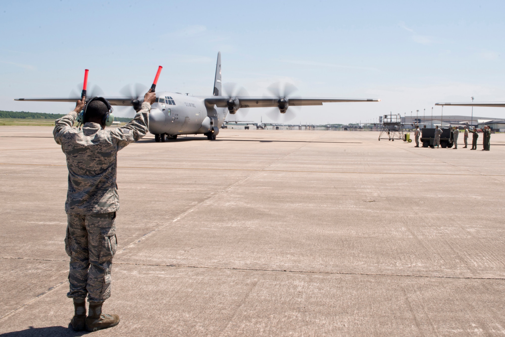 U.S. Air Force Staff Sgt. Kquawmae Akins, a crew chief assigned to the 913th Maintenance Squadron, marshals a C-130J aircraft for takeoff from Little Rock Air Force Base, Ark., May 13, 2016. This is the first time a C-130J aircraft has been manned by an all Reserve aircrew since the 913th Airlift Group’s transition from the “H” model to the “J” model. (U.S. Air Force photo by Master Sgt. Jeff Walston/Released)