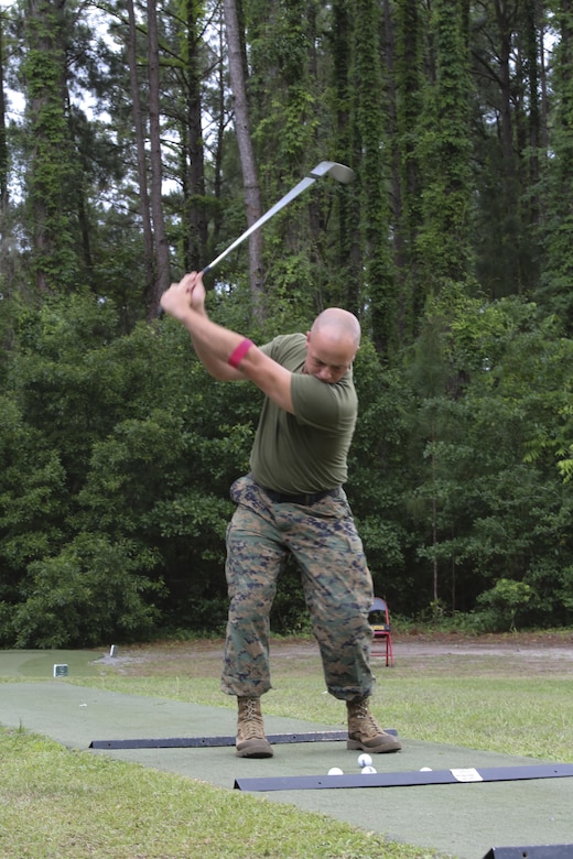 Gunnery Sgt. Michael Haga swings a golf club aboard Marine Corps Air Station Beaufort May 18. Haga is participating in Stroke of Luck, a competition set up by Marine Corps Community Services, for a free round of golf at the Legends Golf Course aboard Marine Corps Recruit Depot Parris Island. Haga is with Marine Aircraft Group 31. 
