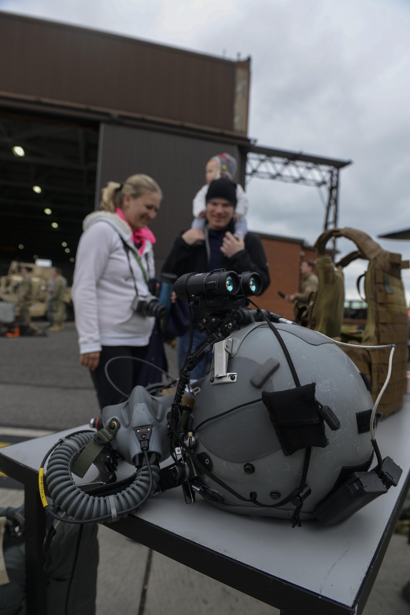 Participants of the 352nd Special Operations Wing Spouses’ Day look at a life support equipment display May 26, 2016, on RAF Mildenhall, England. During the day, Airmen and their families were able to view various displays along with a fast-rope demonstration. (U.S. Air Force photo by Staff Sgt. Micaiah Anthony/Released)