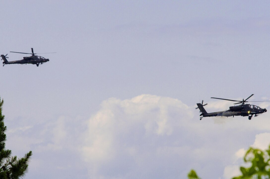An AH-64D Apache helicopter fires a rocket during a joint air attack team exercise at Fort Stewart, Georgia, May 22, 2016. The pilots are assigned to the 3rd Squadron, 17th Cavalry Regiment, 3rd Combat Aviation Brigade. Army photo by Spc. Scott Lindblom