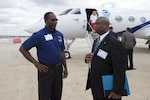 Alvin Hill, 12th Operations Support Squadron Weather Operations Flight chief, speaks with Loyce Clark, San Antonio Airport System assistant aviation director, after touring a National Oceanic Atmospheric Administration Gulfstream IV aircraft during the Hurricane Awareness Tour at the San Antonio International Airport May 16, 2016. The NOAA G-IV is used to collect, process and transmit vertical atmospheric soundings in the environment of a hurricane using a dropsonde, which is an instrument dropped from the aircraft carried by a parachute that transmits information about temperature, pressure and humidity. 