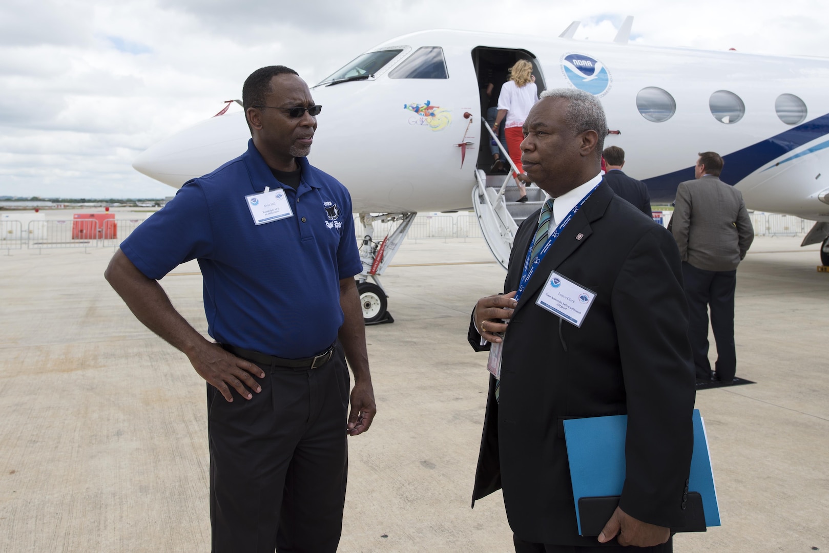 Alvin Hill, 12th Operations Support Squadron Weather Operations Flight chief, speaks with Loyce Clark, San Antonio Airport System assistant aviation director, after touring a National Oceanic Atmospheric Administration Gulfstream IV aircraft during the Hurricane Awareness Tour at the San Antonio International Airport May 16, 2016. The NOAA G-IV is used to collect, process and transmit vertical atmospheric soundings in the environment of a hurricane using a dropsonde, which is an instrument dropped from the aircraft carried by a parachute that transmits information about temperature, pressure and humidity. 