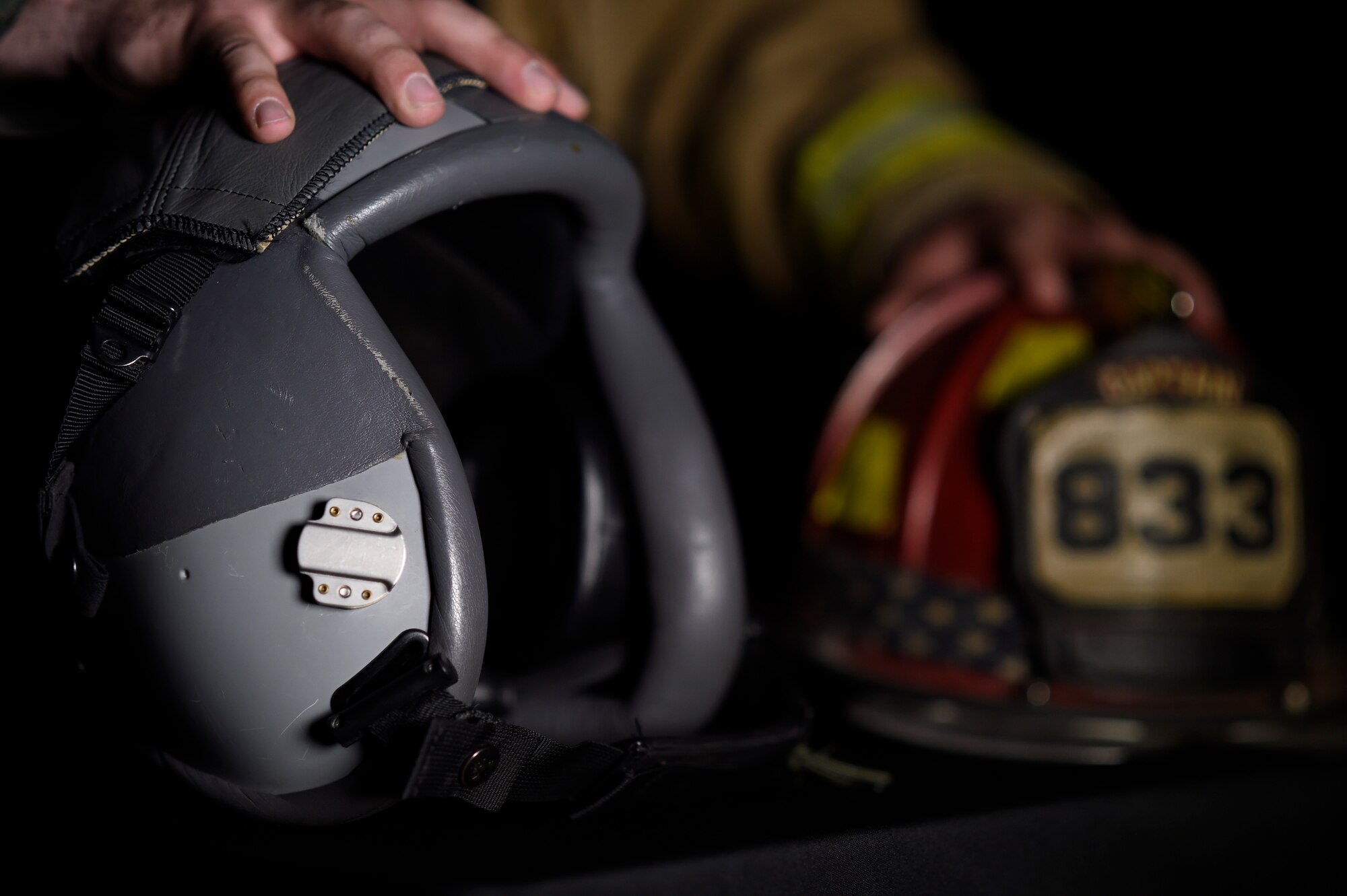 Staff Sgt. Garrett Christensen, 56th Civil Engineer Squadron logistics NCO in charge, displays safety gear from his current job as a fire fighter and his dream job of a fighter pilot April 14, 2016 at Luke Air Force Base, Ariz. Christensen has been selected for Basic Officer Training School with the ultimate goal of becoming a fighter pilot.  (U.S Air Force photo by Staff Sgt. Staci Miller)