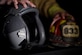 Staff Sgt. Garrett Christensen, 56th Civil Engineer Squadron logistics NCO in charge, displays safety gear from his current job as a fire fighter and his dream job of a fighter pilot April 14, 2016 at Luke Air Force Base, Ariz. Christensen has been selected for Basic Officer Training School with the ultimate goal of becoming a fighter pilot.  (U.S Air Force photo by Staff Sgt. Staci Miller)