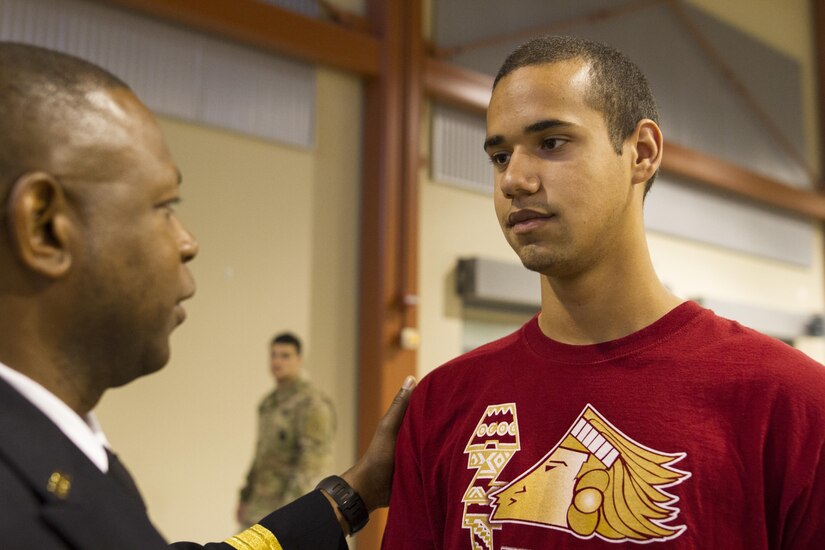 Caleb Lege, a graduating senior assigned to the 83rd Military Police Company, receives words of advice from Maj. Gen. Phillip M. Churn, the commanding general for the 200th Military Police Command, at a high school award ceremony that was held at the 83rd Military Police Company in El Paso, Texas on May 21, 2016. The ceremony recognized over 80 high school seniors for their decision to join the Army after school graduation. (U.S. Army photo by Spc. Stephanie Ramirez)  