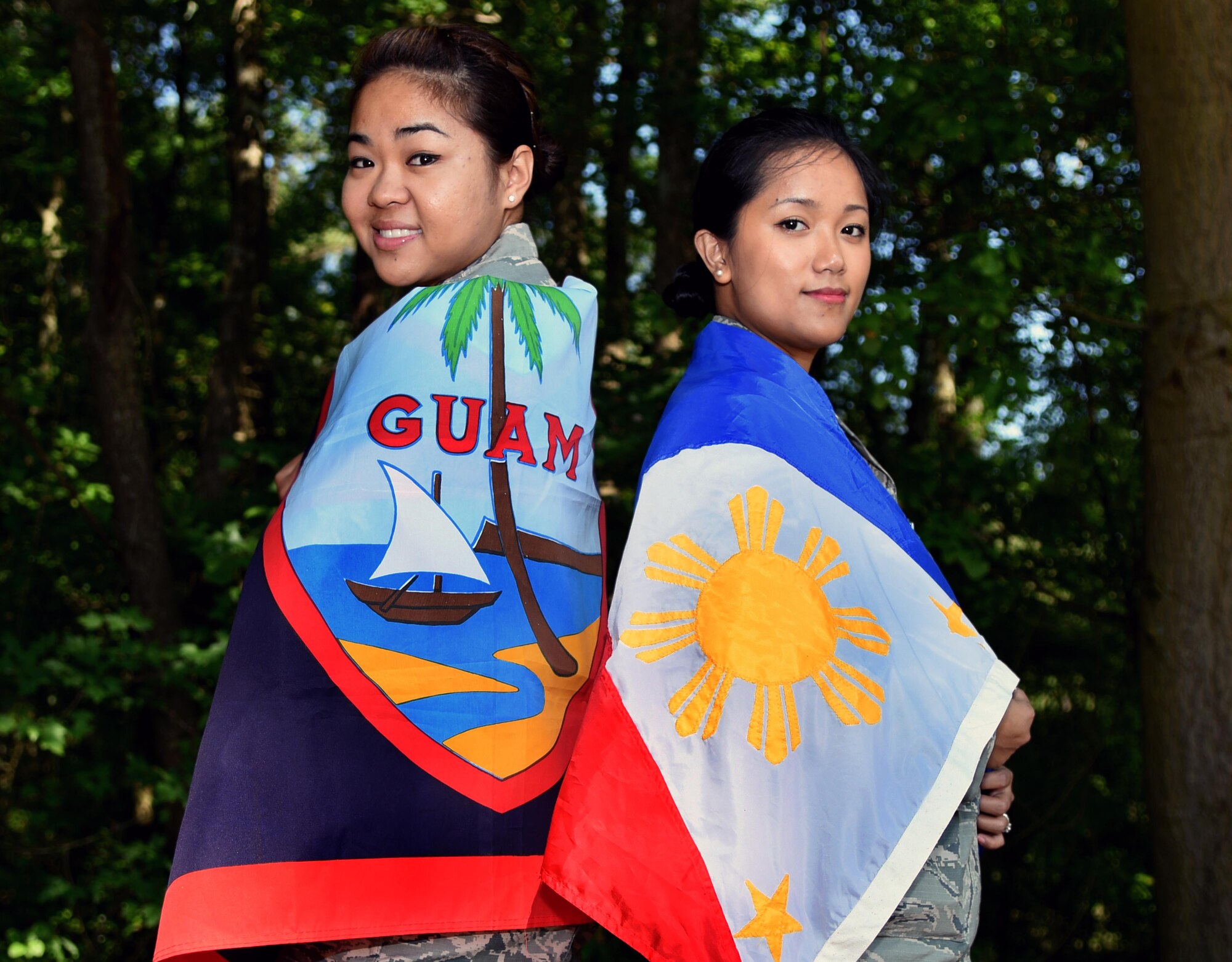 Senior Airman Melissa Punzalan (left), 4th Aerospace Medicine Squadron deployment medicine technician, and Staff Sgt. Janna Matthews, 4th Medical Operations Squadron NCO in-charge of pediatrics, wrap themselves in their native flags of Guam and the Philippines, respectively, May 25, 2016, at Seymour Johnson Air Force Base, North Carolina. Both Airmen enjoy cooking their native cuisine and sharing it with friends and co-workers. (U.S. Air Force photo by Airman Shawna L. Keyes/Released) 