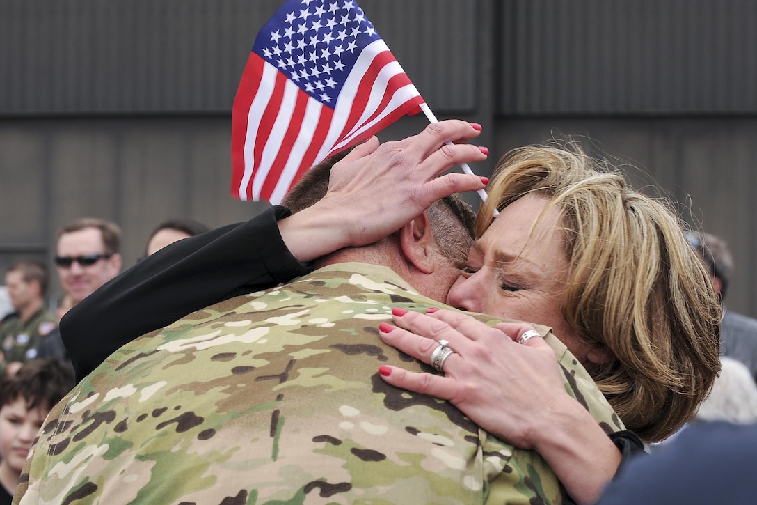 A spouse embraces her husband after he returned to Peterson Air Force Base, Colo., May 18, 2016, from a four-month deployment. About 150 Air Force reservists and four C-130 Hercules assigned to the 302nd Airlift Wing returned from Al Udeid Air Base, Qatar, where they supported Operations Freedom’s Sentinel and Inherent Resolve.  Air Force photo by Staff Sgt. Amber Sorsek