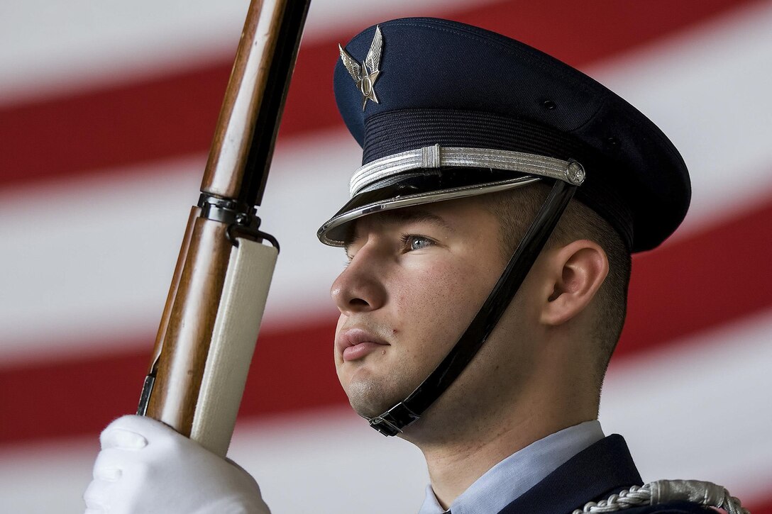 Airman 1st Class Andrew Des Marias stands at the position of port arms before the start of the 436th Maintenance Group change-of-command ceremony on Dover Air Force Base, Del., May 24, 2016. Des Marias is assigned to the 436th Aerial Port Squadron as a fleet service specialist when not performing honor guard duties. Air Force photo by Roland Balik