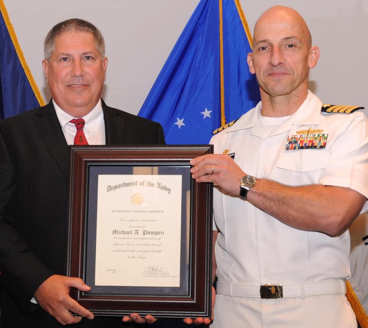 DAHLGREN, Va. - Naval Surface Warfare Center Dahlgren Division (NSWCDD) Commanding Officer Capt. Brian Durant presents Michael Pompeii with the Navy Superior Civilian Service Award at the NSWCDD Annual Honor Awards ceremony on May 18, 2016. Pompeii was honored for his numerous substantial contributions to Naval Sea Systems Command as Chief Engineer for the NSWCDD Chemical, Biological, and Radiological (CBR) Defense Division. "Mr. Pompeii has provided leadership to CBR Defense equipment designs, influenced CBR Defense policy and shipboard procedures, and increased the Navy's CBR Defense scientific, engineering, and test capabilities," according to the citation. "He has challenged the status quo to define more realistic threats and has spearheaded several cost reduction initiatives that simultaneously achieved multi-million dollar savings for the Navy and increased fleet CBR Defense readiness."