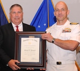 DAHLGREN, Va. - Naval Surface Warfare Center Dahlgren Division (NSWCDD) Commanding Officer Capt. Brian Durant presents Michael Pompeii with the Navy Superior Civilian Service Award at the NSWCDD Annual Honor Awards ceremony on May 18, 2016. Pompeii was honored for his numerous substantial contributions to Naval Sea Systems Command as Chief Engineer for the NSWCDD Chemical, Biological, and Radiological (CBR) Defense Division. "Mr. Pompeii has provided leadership to CBR Defense equipment designs, influenced CBR Defense policy and shipboard procedures, and increased the Navy's CBR Defense scientific, engineering, and test capabilities," according to the citation. "He has challenged the status quo to define more realistic threats and has spearheaded several cost reduction initiatives that simultaneously achieved multi-million dollar savings for the Navy and increased fleet CBR Defense readiness."