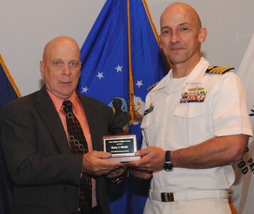 DAHLGREN, Va. - Naval Surface Warfare Center Dahlgren Division (NSWCDD) Commanding Officer Capt. Brian Durant presents Barry Mohle with the John Adolphus Dahlgren Award for sustained leadership and technical excellence across the test and evaluation community at the NSWCDD Annual Honor Awards ceremony on May 18, 2016. "Mr. Mohle's commitment to implementation of robust business practices, technological advances and workforce development ensures the continued excellence of our test and evaluation workforce's contributions to the Navy," according to the citation. 