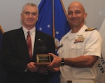 DAHLGREN, Va. - Naval Surface Warfare Center Dahlgren Division (NSWCDD) Commanding Officer Capt. Brian Durant presents Dohn Burnett with the John Adolphus Dahlgren Award for his years of exceptional technical and organizational leadership of NSWCDD at the command's Annual Honor Awards ceremony on May 18, 2016. "Mr. Burnett achieved numerous technical milestones throughout his exemplary career, including the integration and installation of the Aegis Baseline 9 combat system, basis cyber capability integration, establishment of the Fast Frigate Program, and the foundation for integration of railgun and laser systems into surface combatants," according to the  citation.