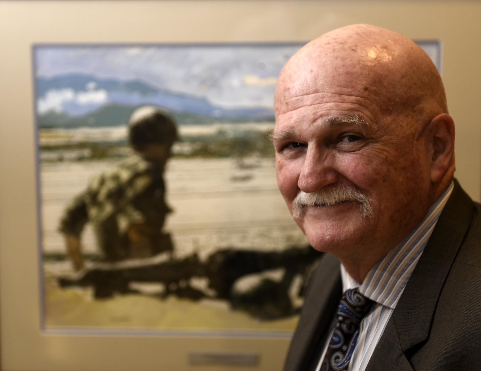 Bradley Riker, a Vietnam veteran who currently works as an Air Force intelligence staff officer, attends the opening of the 50th commemoration of the Vietnam War art display in the Air Force Art Gallery located in the Pentagon, Washington, D.C., May 26, 2016. According to Riker, the painting that spoke to him the most was “Perimeter Guard – Cam Ranh Bay, F-4” because he actually lived on the hill shown in the painting. (U.S. Air Force photo/Tech. Sgt. Bryan Franks)