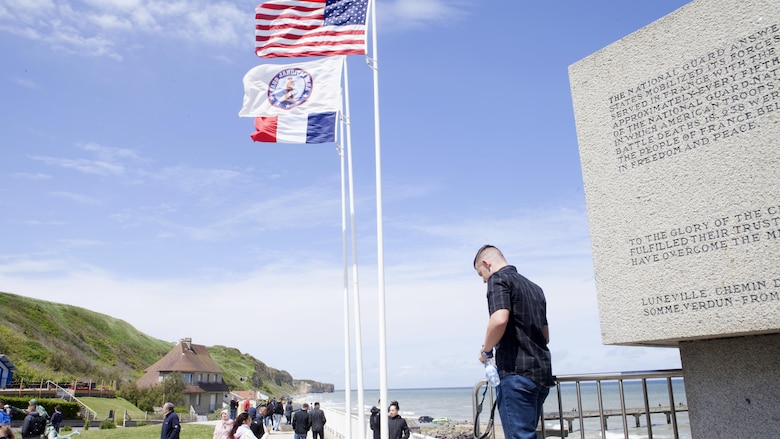 Flags of the United States and France fly next to a monument for the United States National Guard, where Marines explore Omaha Beach at Vierville sur Mer, France, May 25, 2016. More than 70 Marines took part in a five-day, professional military education trip to France to learn about U.S. military history. 
