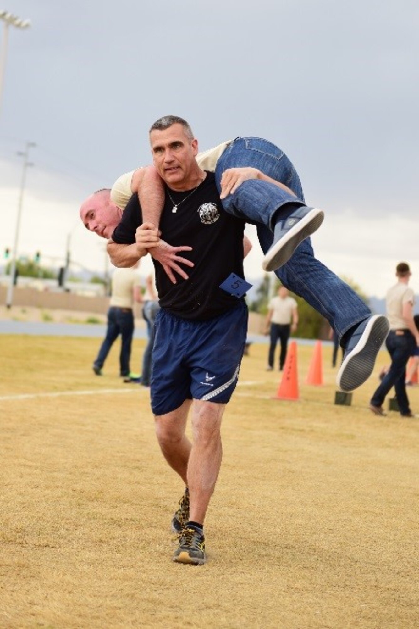 Master Sgt. Kevin Perlak, 944th Security Forces Squadron superintendent, performs a fireman carry as part of a team relay race during the 944th Fighter Wing Physical Training Challenge, April 30, 2016. Perlak's team of four won first place with a time of 11 minutes and 15 seconds, 38 seconds faster than the second place team.