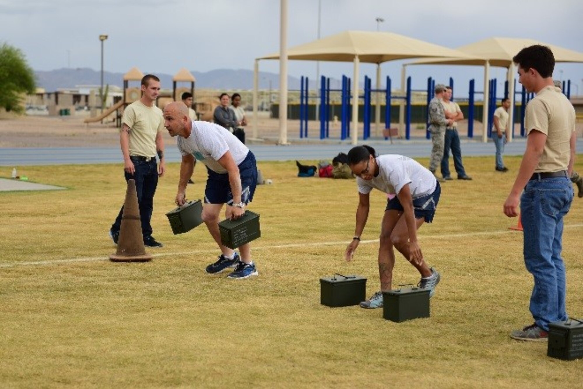Master Sgt. Michael Orso, 944th Logistics Readiness Squadron vehicle maintenance manager, and Senior Airman Krystal Broady, 944th Fighter Wing Det 1 commander support staff, carry 20-pound ammo cans as part of a team relay race during the 944th FW Physical Training Challenge, April 30, 2016. A total of nine four-person teams competed in this month's challenge. 