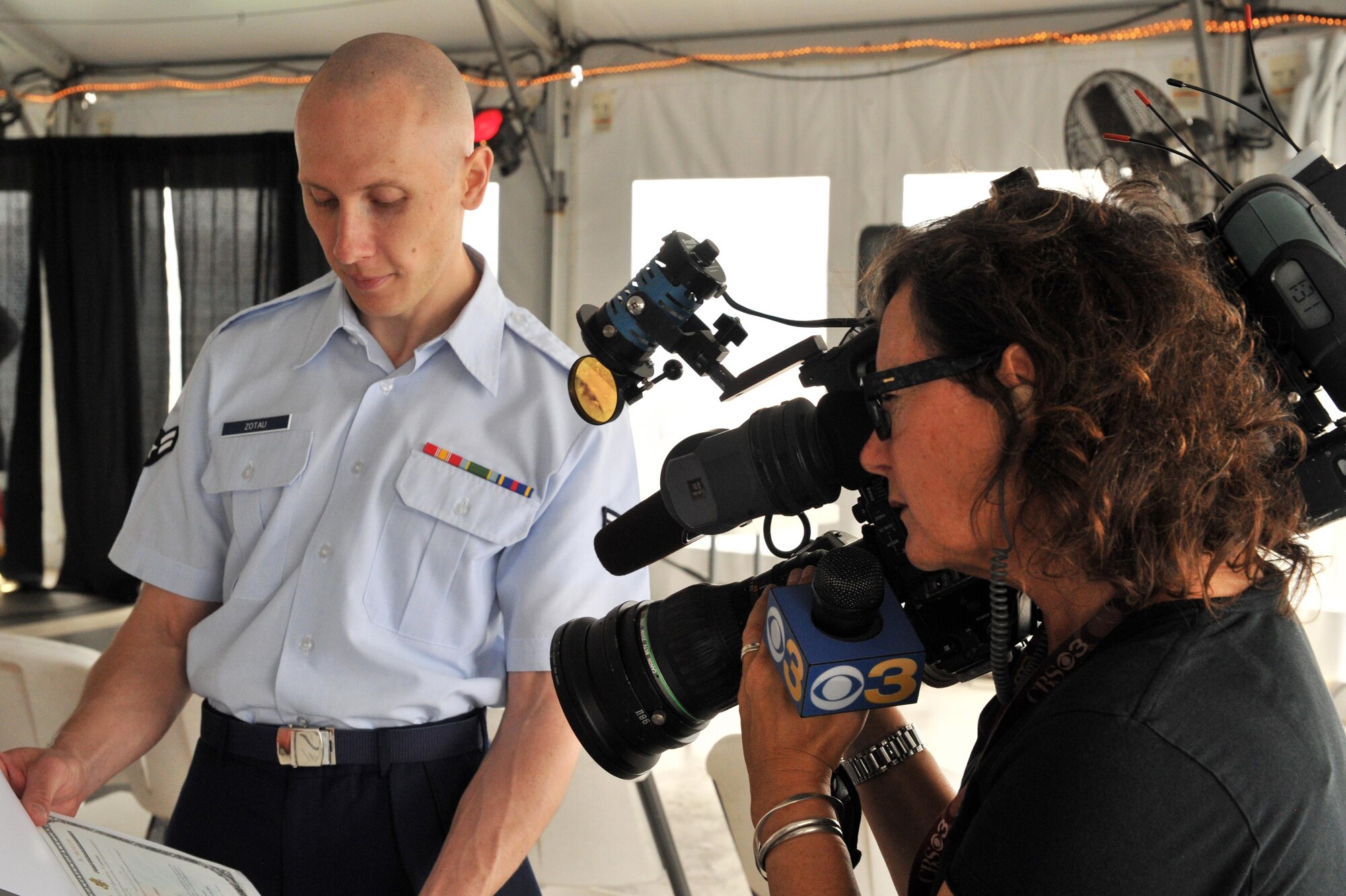 Airman first class Ilya Zotau shows his U.S. Citizen certificate to a CBS reporter following a naturalization ceremony Monday. Zotau and 38 other people, hailing from 29 countries, took the Oath of Allegiance to the United States on board the Battleship New Jersey, Camden, N.J, following a Memorial Day service hosted by the Knights of Columbus. The Air Force reservist is assiged to the 35th Aerial Port Squadron here. 
