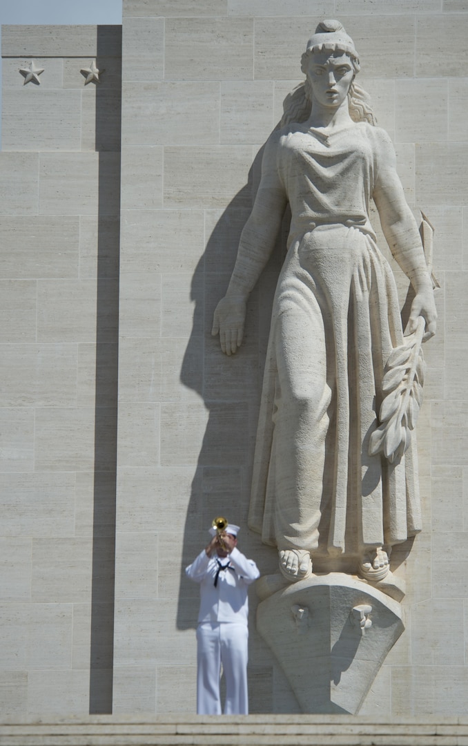 160531-N-UG232-142 Honolulu, Hawaii (May 31, 2016) Musician 1st Class Brandon Barbee plays taps in front of the Lady Columbia during the Honolulu Mayor's Memorial Day Ceremony at the National Memorial Cemetery of the Pacific. The National Memorial Cemetery of the Pacific is a national cemetery located at the Punchbowl Crater in Honolulu.