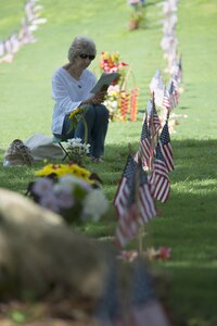 160531-N-UG232-199 Honolulu, Hawaii (May 31, 2016) Barbara Loveless reads the program for the Honolulu Mayor's Memorial Day Ceremony at the National Memorial Cemetery of the Pacific. Ms. Loveless sat by the grave site of her husband, U.S. Army Cpl. Robert Loveless, during the ceremony.  Cpl. Loveless served during World War II and died in 2009.
