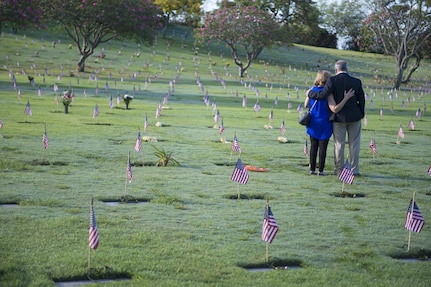 160531-N-UG232-433 Honolulu, Hawaii (May 31, 2016) Karen Spofford and Cos Spofford look over the grave of Air Force Maj. Melvin Souza, Ms. Spofford's Father, before the Honolulu Mayor's Memorial Day Ceremony at the National Memorial Cemetery of the Pacific. Maj. Souza was a pilot who mentored many current pilots, said Ms. Spofford. He died in 2014.