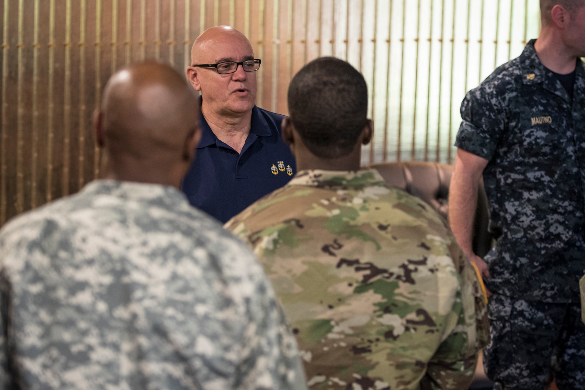 PETERSON AIR FORCE BASE, Colo. - Retired U.S. Navy Master Chief Petty Officer James Parlier, speaks to joint service members following a presentation at the Peterson AFB Club on May 25, 2016. Parlier was the command master chief assigned to the U.S.S. Cole when it was attacked by terrorist on Oct. 12, 2000. He told a story of devastation and how the ship’s small crew rallied together under horrendous conditions to save their ship. (U.S. Air Force photo by Senior Airman Rosemary Gudex)