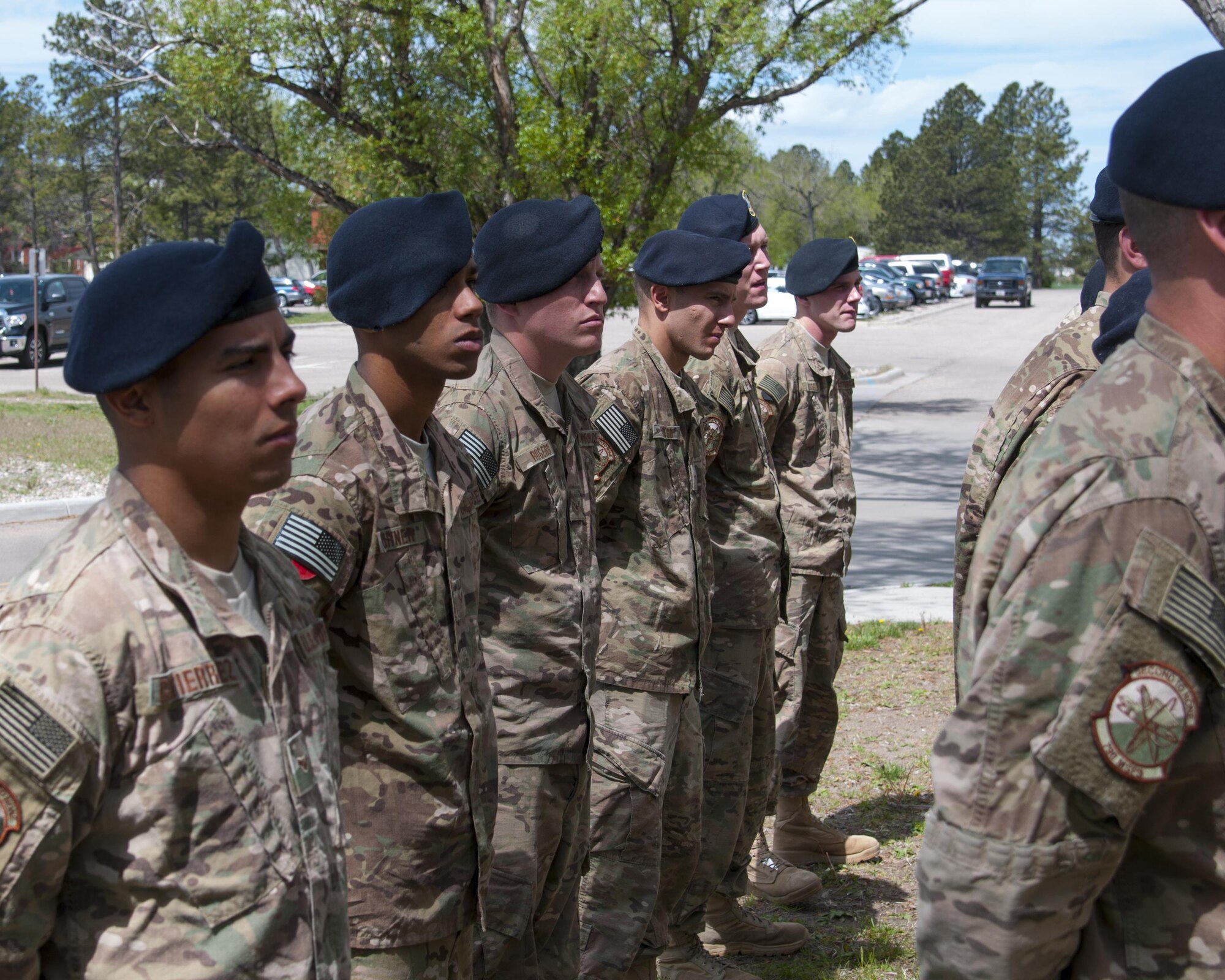 Airmen of the 790th Missile Security Forces Squadron listen to their commander speak at a rededication ceremony for a memorial to fallen defenders on F.E. Warren Air Force Base; Wyo.; May 30; 2016. The 790th MSFS intends to take care of the memorial in the future. (U.S. Air Force photo by Senior Airman Jason Wiese)