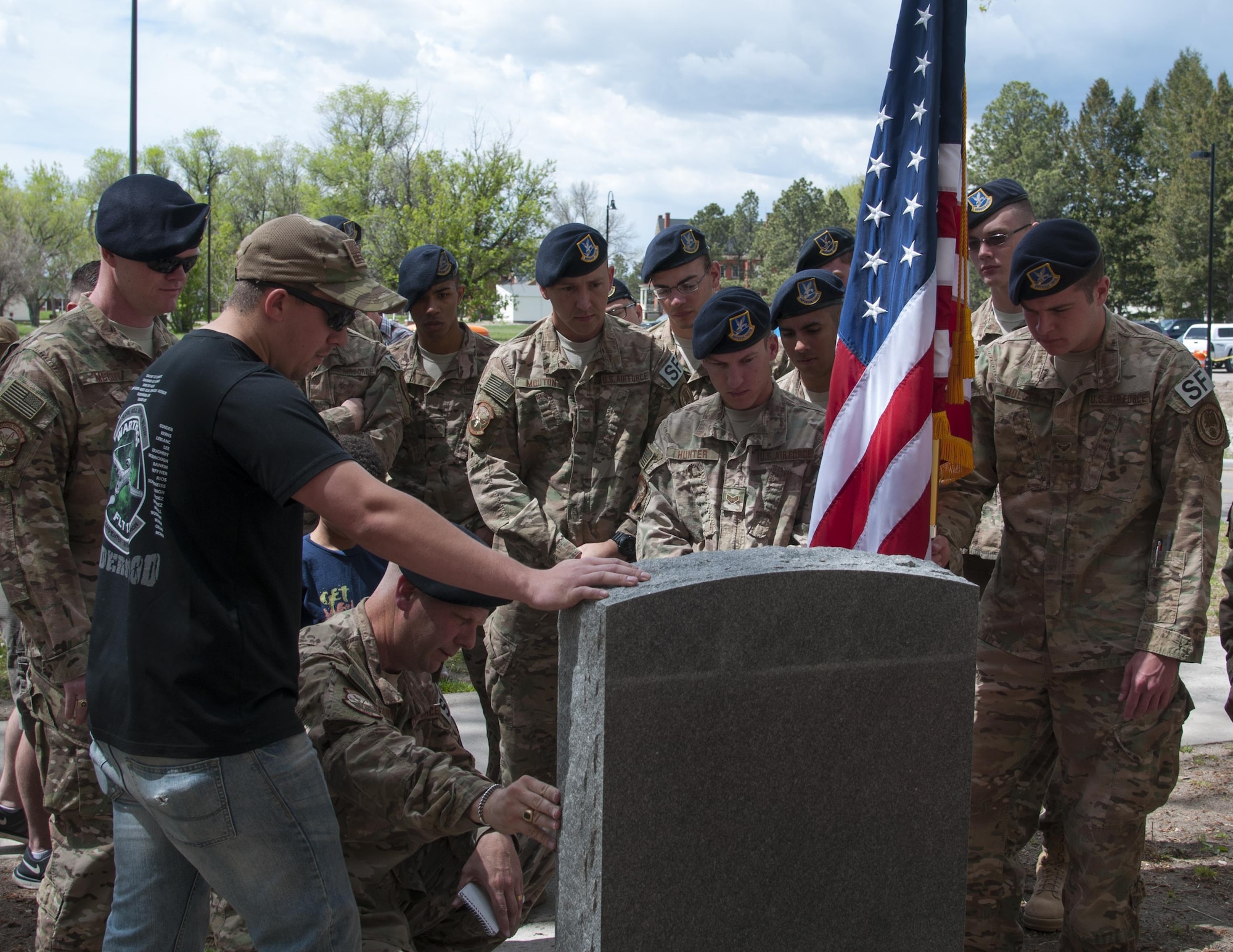 Airmen of the 790th Missile Security Forces Squadron look at the newly unveiled memorial to fallen defenders outside the 90th Security Forces Group building on F.E. Warren Air Force Base, Wyo., May 30, 2016. The unveiling of the newly polished memorial took place on Memorial Day. (U.S. Air Force photo by Senior Airman Jason Wiese)