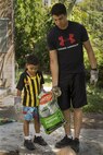 U.S. Marine Lance Cpl. Simon B. Delacruz helps an Australian preschooler spread potting mix onto a garden at Millner Preschool, Northern Territory, Australia, on May 28, 2016. U.S. Marines with Forward Coordination Element, Marine Rotational Force – Darwin, volunteered with preschool teachers and parents to clean up the schoolyard for preschoolers. MRF-D is a six-month deployment of Marines into Darwin, Australia, where they will contribute to and engage with local communities. Delacruz, from Rochester, New York, is a cyber network operator with FCE, MRF-D.
