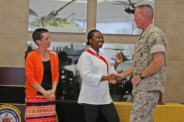 Jackie Murphy, 31 Area Mess Hall General Manager, and Natalie Williams, 31 Area Mess Hall Production Manager, shake hands with Brig. Gen. Edward D. Banta, Commanding General, Marine Corps Installations-West, Marine Corps Base Camp Pendleton, during a ceremony naming Camp Pendleton’s 31 Area Edson Range Mess Hall the Maj. Gen. William Pendleton Thompson Hill Award winners for best full food service mess hall in the Marine Corps, May 31. 

The W.P.T. Hill Award was established in 1985 to improve food service operation and recognize the best messes in the Marine Corps.  