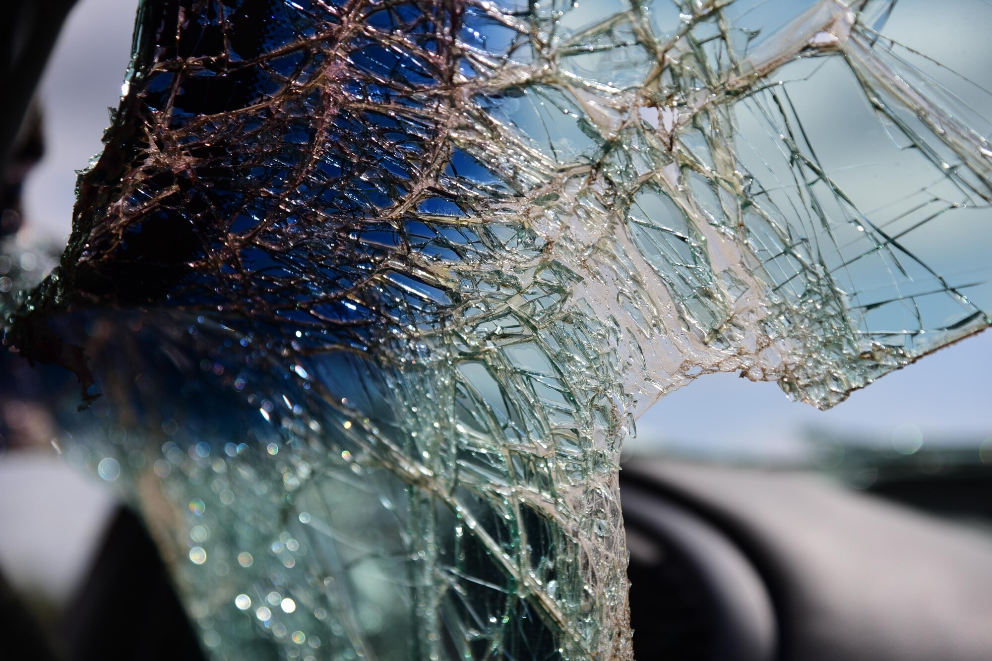 PETERSON AIR FORCE BASE, Colo. - Shattered remnants of a windshield hang inside what’s left of a Mercury Mystique on Peterson Air Force Base, Colo. May 24, 2016. Placed just outside the bases main gate by the 21st Space Wing Safety office, the car shows what a person can walk away from if they use their safety belt. (Air Force photo by Staff Sgt. Amber Grimm)