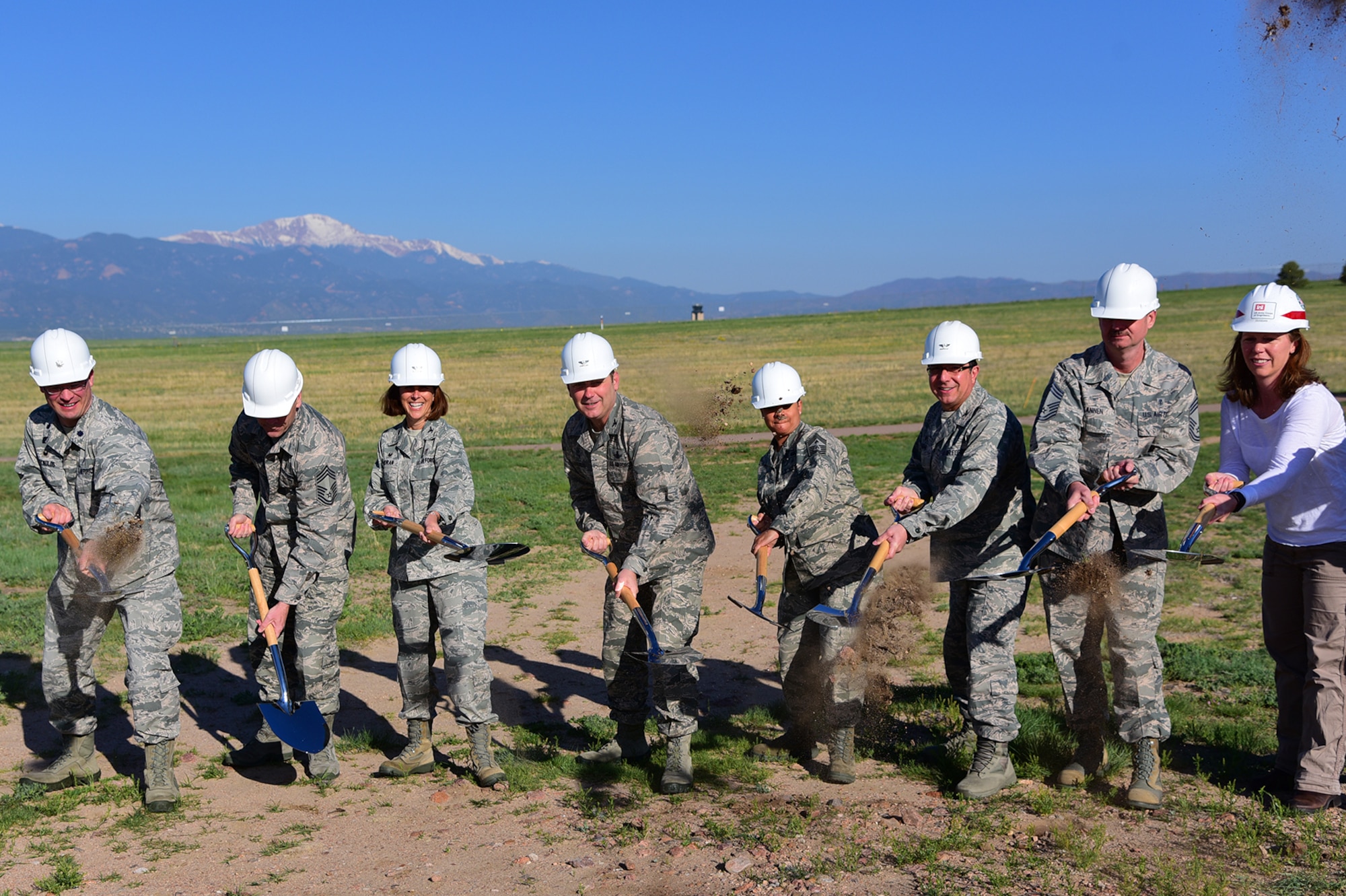 PETERSON AIR FORCE BASE Colo. – Col. Douglas Schiess, 21st Space Wing commander, and Chief Master Sgt. Idalia Peele, 21st Space Wing command chief, assist the 21st Medical Group leadership in breaking ground on where the new dental clinic will be on Peterson Air Force Base, Colo., May 25, 2016. The new clinic is expected to be completed in the fall of 2017. (U.S. Air Force photo by Staff Sgt. Amber Grimm)