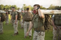 Lance Cpl. Riley Davis, a rifleman, carries a log in preparation for the start of the squad competition at Robertson Barracks, Northern Territory, Australia, May 25, 2016. The squad-level competition determined which rifle squad or weapons platoon section had the best physical fitness, small-unit leadership, and cohesion within Company C. Davis, from San Jose, California, is with 1st Platoon, 2nd Squad, Company C, 1st Battalion, 1st Marine Regiment, Marine Rotational Force – Darwin.
