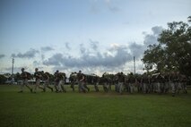 Marines and sailors start a squad competition carrying main packs and logs at Robertson Barracks, Northern Territory, Australia, on May 25, 2016. The squad-level competition determined which rifle squad or weapons platoon section had the best physical fitness, small-unit leadership, and cohesion within Company C, 1st Battalion, 1st Marine Regiment, Marine Rotational Force - Darwin.