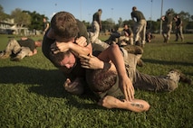 Marines grapple during squad-on-squad ground fighting at Robertson Barracks, Northern Territory, Australia, on May 25, 2016. Squads had to win two bouts or flip tires in order to move on to the next station during the squad competition. The squad-level competition determined which rifle squad or weapons platoon section had the best physical fitness, small-unit leadership, and cohesion within Company C, 1st Battalion, 1st Marine Regiment, Marine Rotational Force - Darwin.