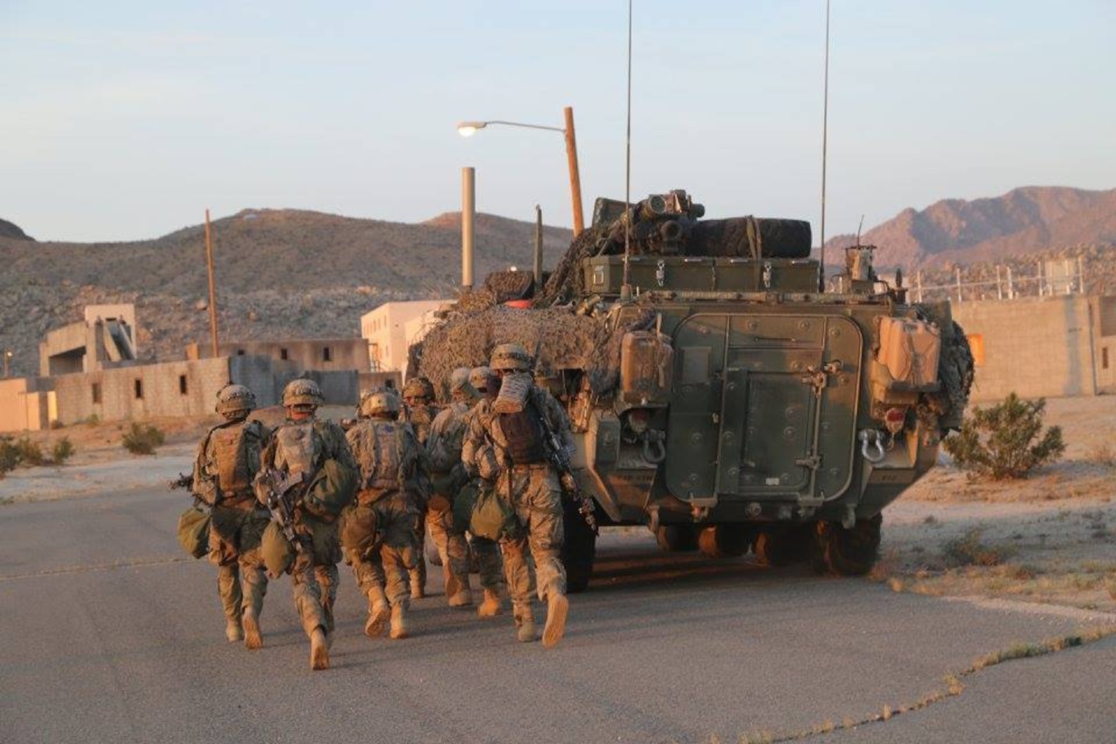 Soldiers assigned to 1st Battalion, 23rd Infantry Regiment, 1-2 Stryker Brigade Combat Team, take cover behind a Stryker, while clearing a city during Decisive Action Rotation 16-06 at the National Training Center in Fort Irwin, Calif., May 11, 2016. The training focused on the 1-2 SBCT combating a near-peer enemy and smaller militant groups in a foreign country. (U.S. Army Photo by Spc. Kyle Edwards, Operations Group, National Training Center)