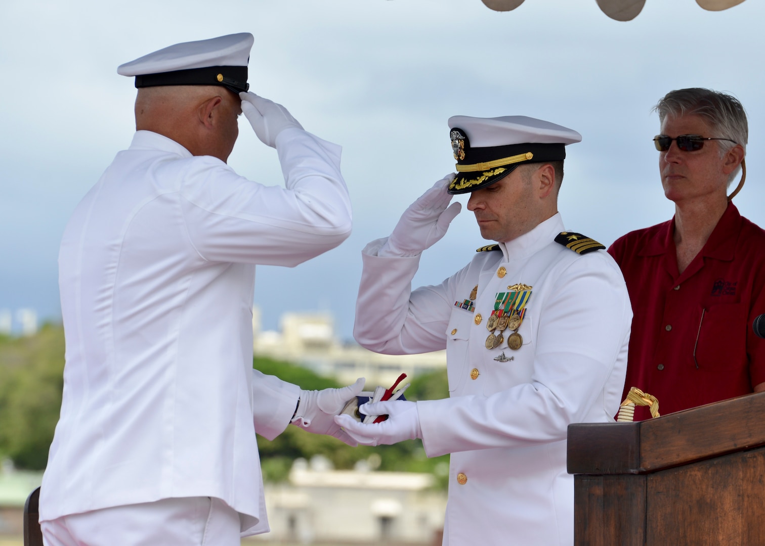 160530-N-LY160-424 JOINT BASE PEARL HARBOR-HICKAM, Hawaii (May 30, 2016) USS City of Corpus Christi’s (SSN 705) chief of the boat, Master Chief Machinist’s Mate Richard D. Magee, left, presents the ship’s commissioning pennant to Cmdr. Travis M. Petzoldt, commanding officer of the Los Angeles-class fast-attack submarine, during a Memorial Day decommissioning ceremony at Joint Base Pearl Harbor-Hickam. City of Corpus Christi concluded 33 years of service as the second U.S. warship to be named after Corpus Christi, Texas. (U.S. Navy photo by Mass Communication Specialist 2nd Class Michael H. Lee)