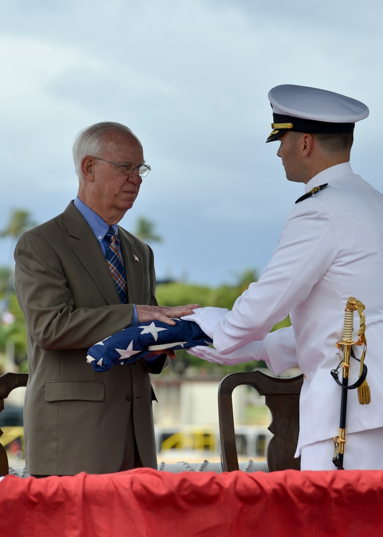 160530-N-LY160-433 JOINT BASE PEARL HARBOR-HICKAM, Hawaii (May 30, 2016) Commander Travis M. Petzoldt, commanding officer of the Los Angeles-class fast-attack submarine USS City of Corpus Christi (SSN 705), presents the ship’s national ensign to Rear Adm. (ret.) Winford G. “Jerry” Ellis, City of Corpus Christi’s first commanding officer and former commander of the Pacific Submarine Force, during a Memorial Day decommissioning ceremony at Joint Base Pearl Harbor-Hickam. City of Corpus Christi concluded 33 years of service as the second U.S. warship to be named after Corpus Christi, Texas. (U.S. Navy photo by Mass Communication Specialist 2nd Class Michael H. Lee)